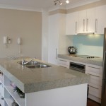 The combination of the light gray granite countertop with white walls