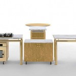 autonomous modular kitchen parts surrounded by rectangular worktop and contrasted by circular table