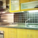blue gray color of the granite countertop with the bold yellow cabinetry