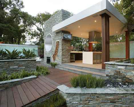 outdoor kitchen or open air kitchen linked with pool and garden