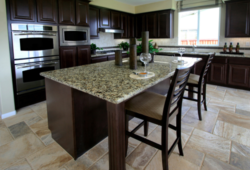 gorgeous slab of granite counter top extends well beyond the island cabinets
